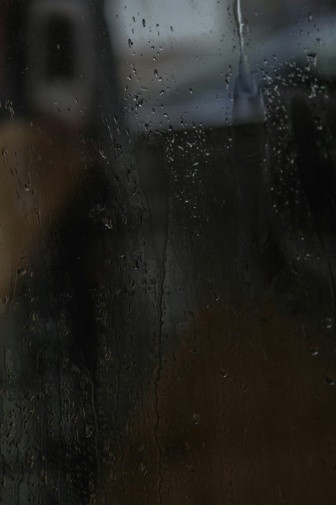 water dripping down dark window